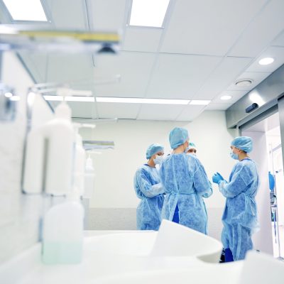 group of surgeons in operating room at hospital